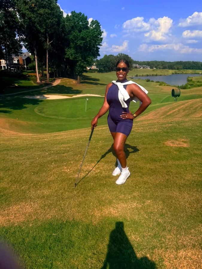 Girls Girl Golfing founder posing on the fairway with a golf club